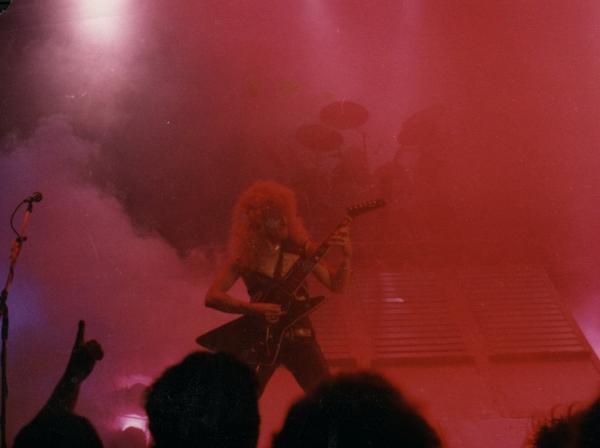 Banshee performing under red stage lights